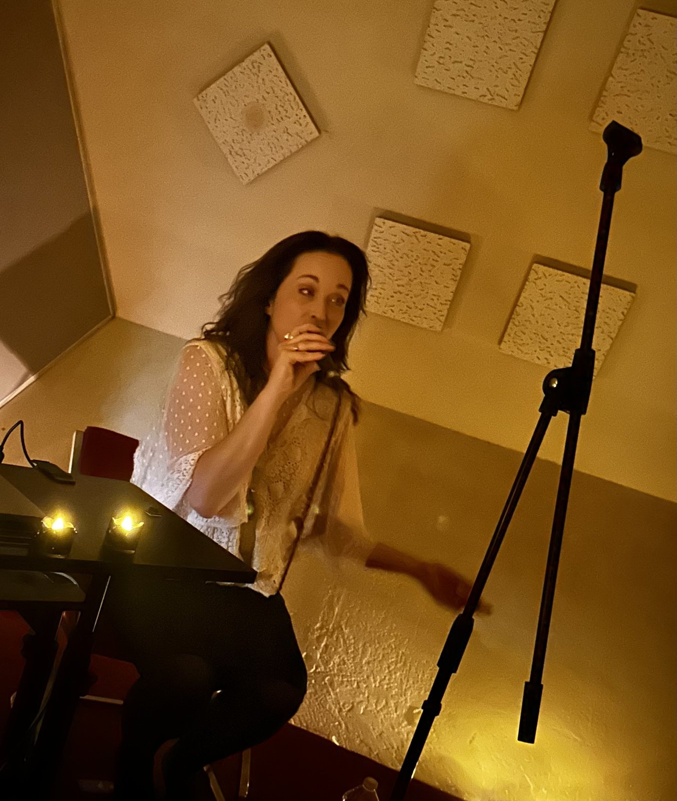 Sariah sings by candlelight during the Honey Gold performance at Audium