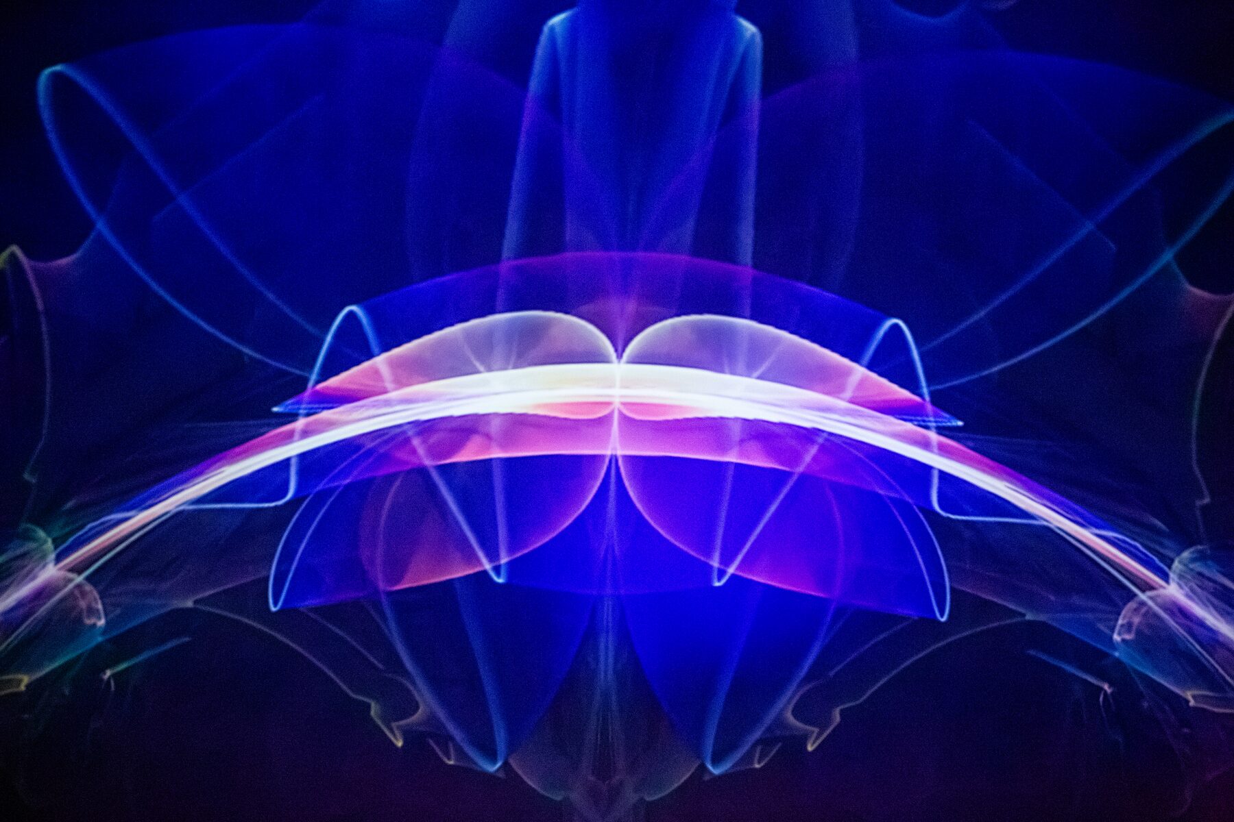 Mirrored blue and pink ribbons of light bloom in perfect symmetry across the dome