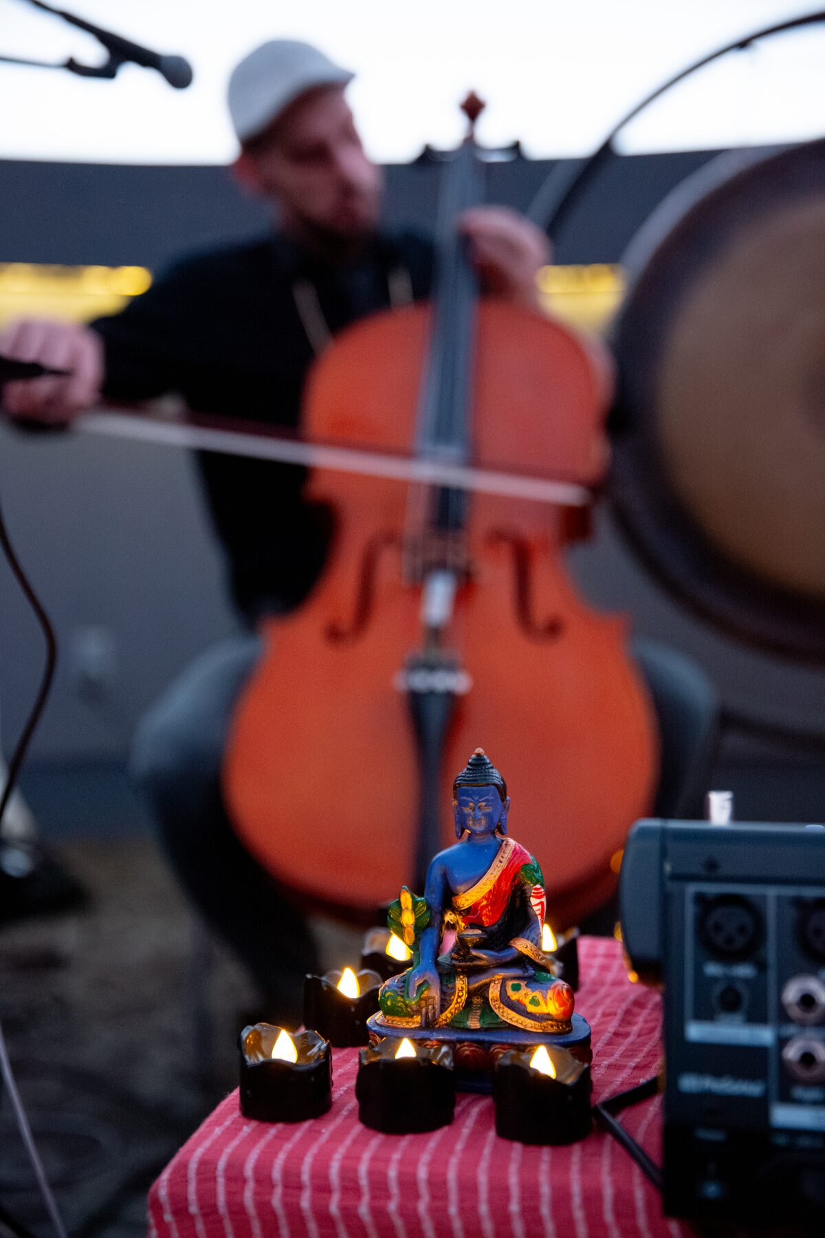 Taylor plays cello behind a candlelit altar during soundcheck before the Dome Debut