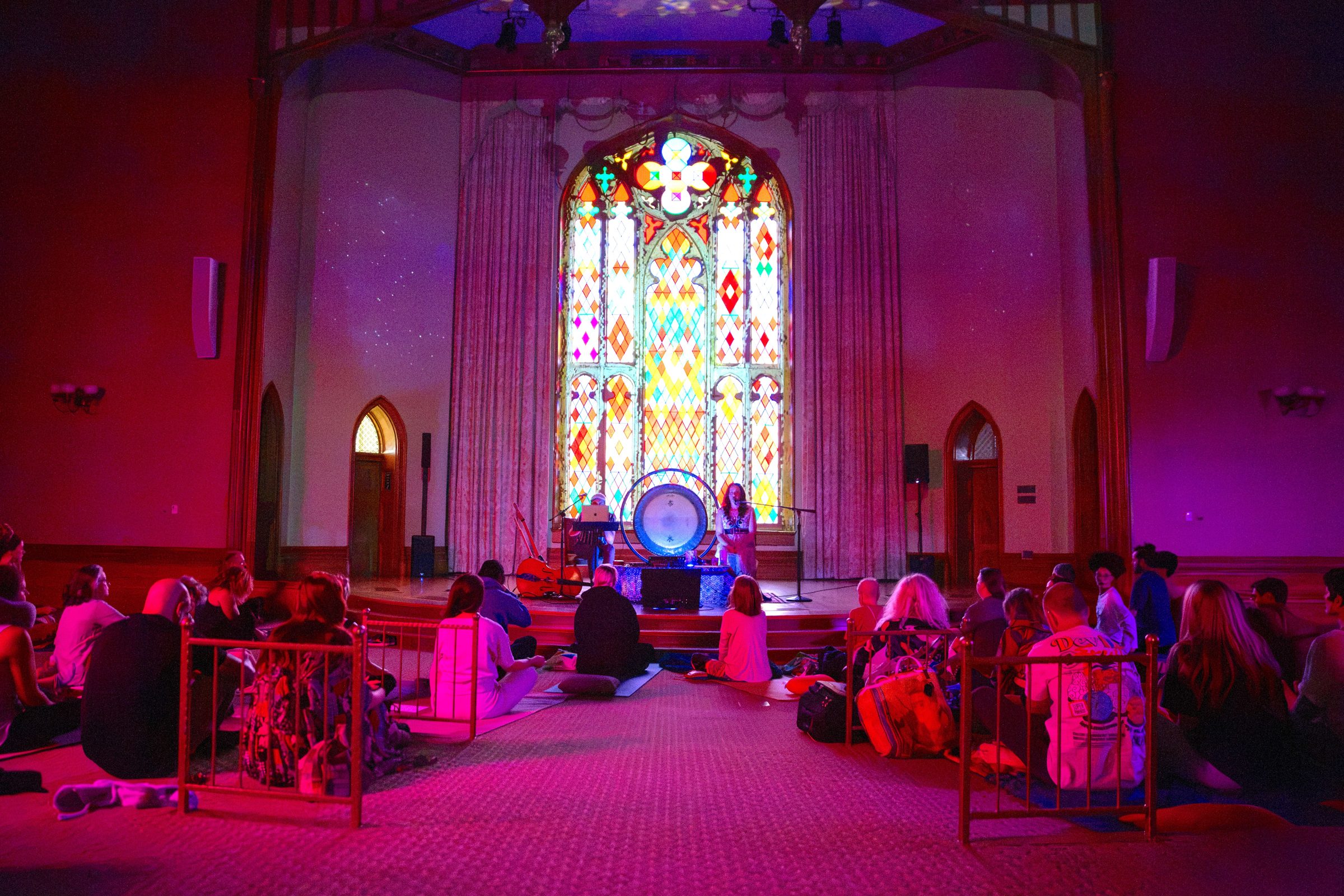 Sariah and Taylor perform beneath the stained glass window at Louisiana's Old State Capitol as the audience sits on the floor